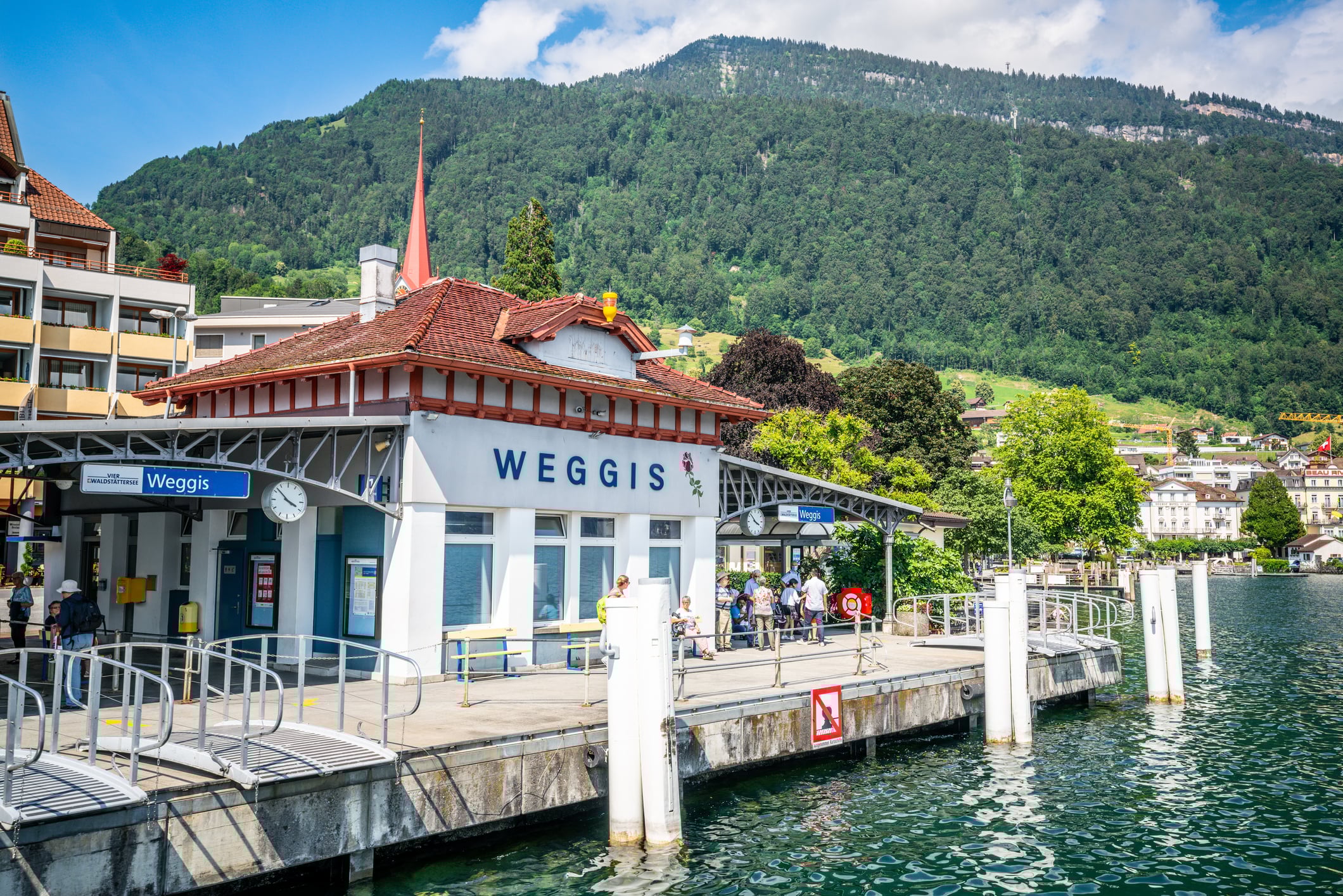 Weggis jetty stop for touristic boats on Lucerne lake and people in Switzerland iStock 1267308067 31